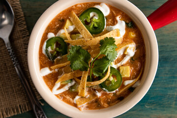 thai noodle soup with pork, tortilla and cilantro.
