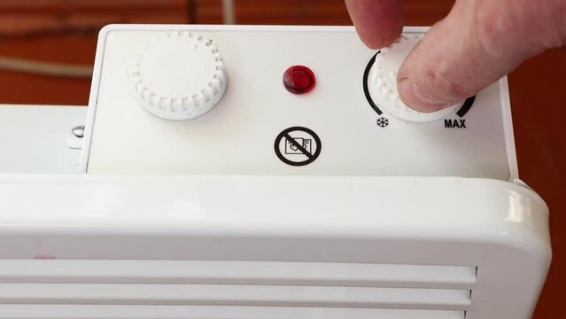 Switching off convector heater at end of heating season.