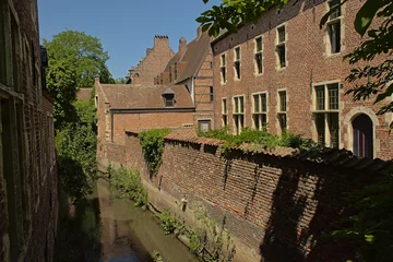 Deurstickers Canal in between medieval houses in Groot Begijnhof beguinage, UNESCO world heritage site in  Leuven, Flanders, Belgium © Kristof Lauwers