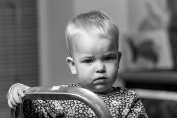 Little girl on a stepladder, black and white portrait