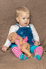 A little girl and a doll