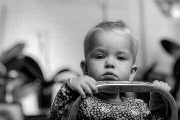 Little girl on a stepladder, black and white portrait