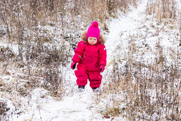 A little girl in the harsh northern winter