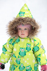 A little girl in the harsh northern winter