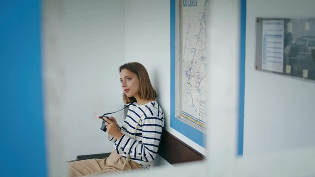 Passenger waiting public transport on summer trip. Beautiful girl travel alone