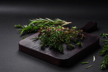 Sprigs of fresh green thyme on a wooden cutting board