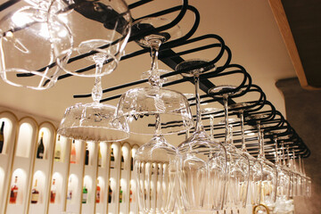 close-up of wine glasses hanging in a restaurant, suspended