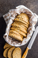 Sliced whole grain bread. Tasty wholegrain pastry with seeds in baket. Top view.