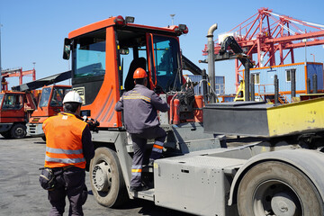 Tow and transporter trucks working  ort he transport of steel sheet rolls in the port area