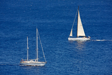 Two sailing boats crossing at the ocean
