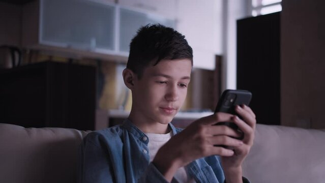 Teenage Boy Using Phone on Sofa - Chatting with Friends, Playing Games, Cinematic Shot