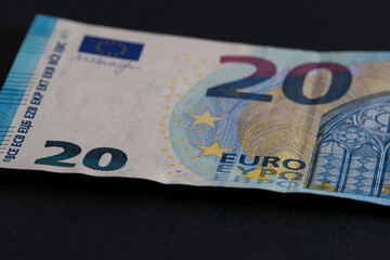 Obraz premium 20 euro banknote on black background close-up. Paper money banknote. Soft focus