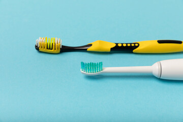 Electric and manual toothbrushes on a colored background. Oral hygiene. Ordinary toothbrush and electric toothbrush prevent caries. Dental car. Dentistry concept. place for text.