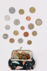 Open wallet with different coins isolated on white background top view. Financial crisis, poverty, lack of money concept