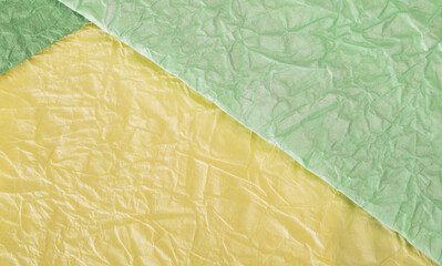 texture of crumpled colored light green and yellow gift paper for banner background