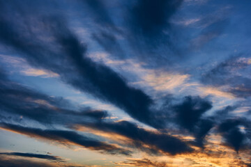 Obraz premium Landscape of the summer sky at sunset, clouds of different colors and bizarre shapes create a beautiful picture, natural texture