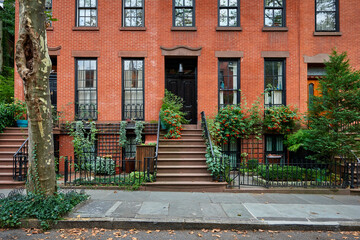 Fototapeta na wymiar a view of a row of historic brownstones in an iconic neighborhood of Manhattan, New York City