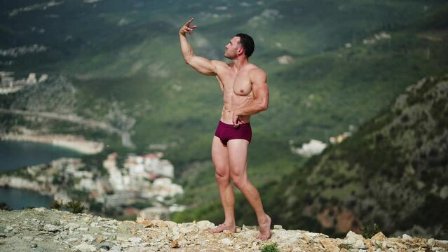 Male athlete beautiful body posing in nature outdor in shorts