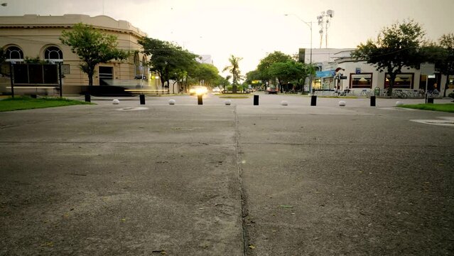 As the sun sets over the quaint town, a dynamic and bustling scene unfolds as people come and go, creating a beautiful and vibrant tapestry of life