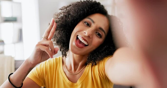 Kiss, peace sign and video call with black woman in living room for blog, social media and connection. Happy, hello and communication with girl vlogger at home for app, chatting and live streaming