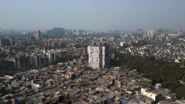 Aerial view of Dharavi slums and Mumbai cityscape in Mumbai, Maharashtra, India. Dharavi is considered to be one of the largest slums in the world and the largest in Asia.