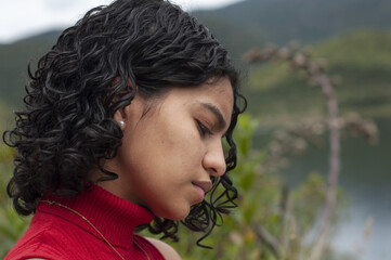 Beautiful concentrated Latina woman contemplating natural landscape