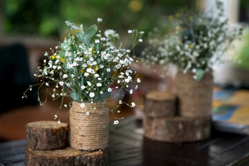 Baby daisy flower vase decorated with rope on the table
