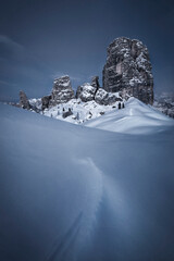 Cinque Torri rock formations in the blue hour during a snowy winter in Cortina d'Ampezzo, Italy