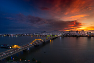 Night scenery of Da Nang city, Vietnam with the magic of light from the bridges, buildings, and daydreaming of the river flowing to the sea