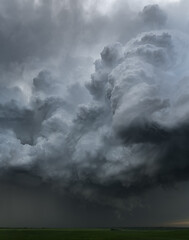 Storm building over green fields