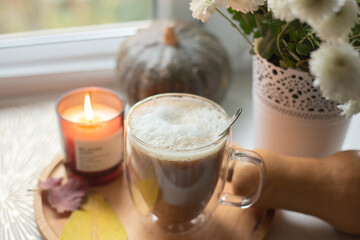 Coffee on the windowsill with autumn decor