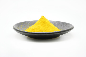 Curry powder on black ceramic dishes isolated on white background
