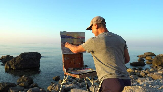 Art Therapy Nature Oil Painting. The artist paints a seascape