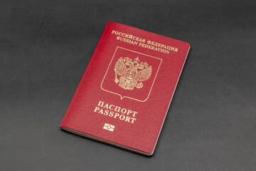 Russian travel passport on a black background, sanctions, emigration, immigration, tourism concept