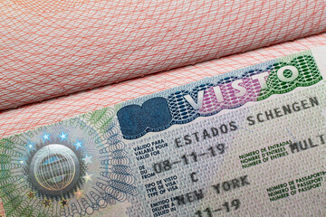 Italian visa stamp in a travel passport, Italy Schengen visa, immigrant, work and travel documents,...