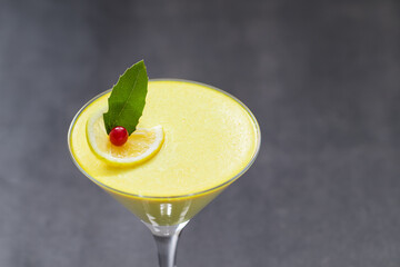 Lemon Panna Cotta in a martini glass. Dark gray background