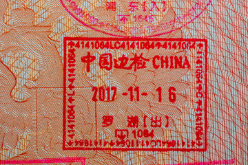 Chinese stamp in a travel passport, entry and exit stamp, China emigration, immigration, tourism concept