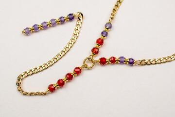 Colorful gemstone crystal beads necklace on white, unique handmade jewelry background