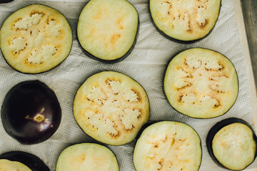 sliced eggplant aubergine rings, washed and drying on paper towel