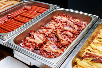 Fried bacon at the hotel breakfast buffet.