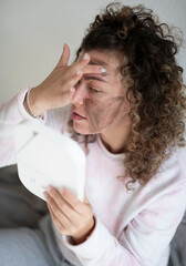 Young beautiful woman making a facial mask at home, beaty treatment at home concept 