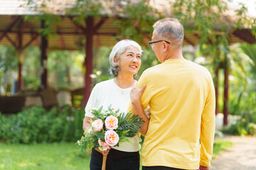 Never stop loving each other, Asian people elderly husband and wife relaxing in park outdoor in springtime.