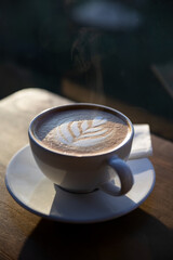 A cup of latte, latte art coffee, back light photography