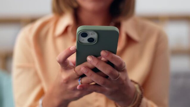 Woman, hands and phone on sofa for social media, chatting or texting in living room at home. Closeup of female hand typing on smartphone for chat, browsing or mobile app on the lounge couch indoors