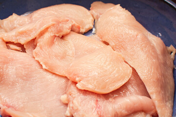 Raw chicken meat breast, seasoned, close up view