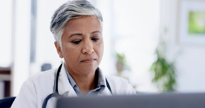 Healthcare, laptop and woman doctor doing research in office in the hospital after consultation. Technology, professional and senior female medical worker analyzing test results in a medicare clinic.