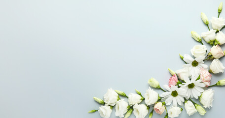 Beautiful composition with delicate flowers on light background with space for text