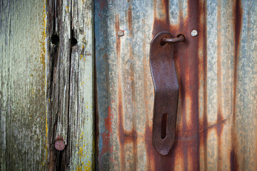 Closeup of an Old Weathered Cannery Building With Rusted Metal Parts. Detail shot of a dilapidated wood and brown rusty parts left over from a long forgotten salmon cannery. Semiahmoo, Washington. - obrazy, fototapety, plakaty