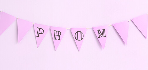 Paper bunting flags with word PROM on light lilac background