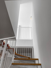 View of beautiful stairs with railing in light room